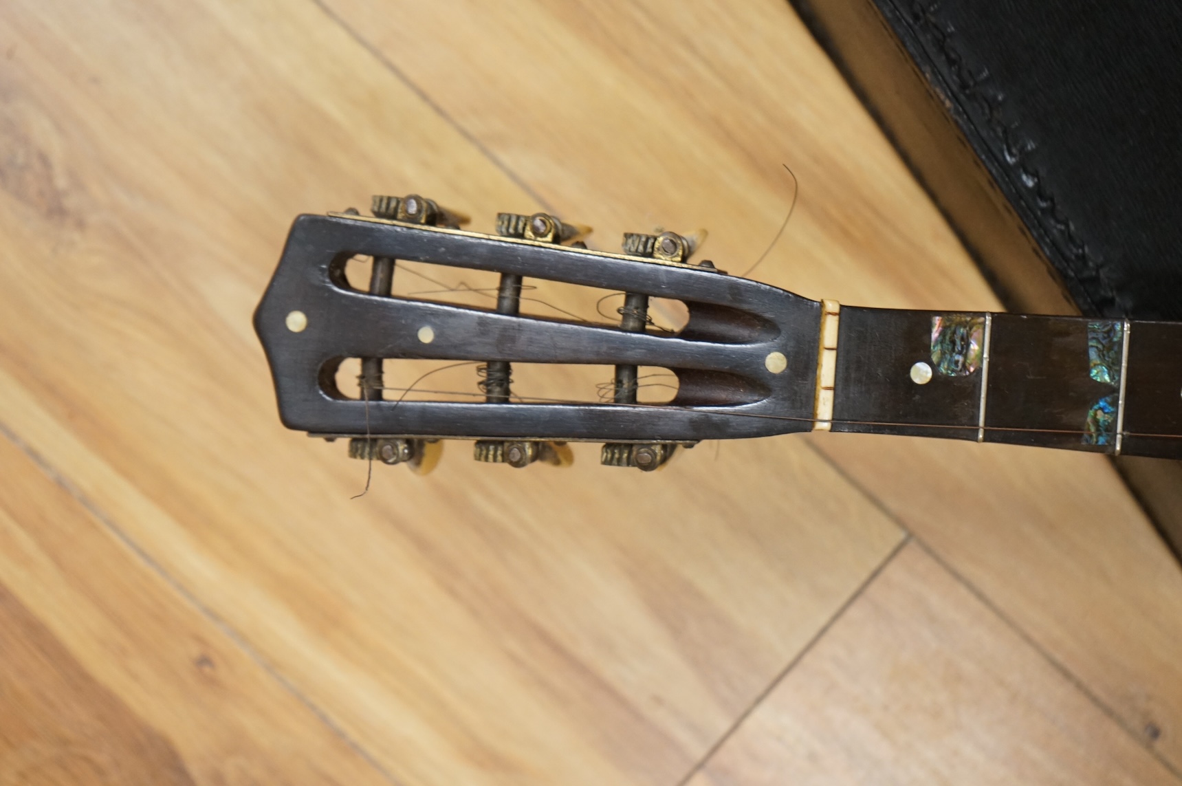 A rosewood banjo with mother of pearl inlay, cased
